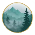 Circular forest and mountain logo with a gold textured border, showing mist-covered evergreen trees and distant blue-green peaks.